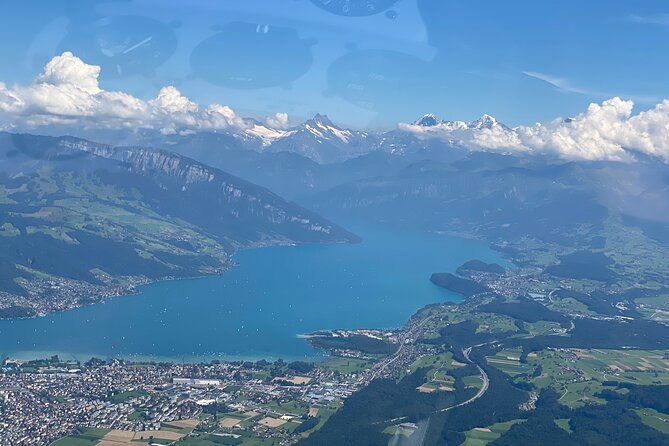 Helicopter tour to the Stockhorn mountain, with great view to the Swiss Alps - Niesen mountain, triangular shadow, cog railway and the restaurant from above