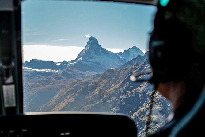 Matterhorn helicopter tour - longest scenic flight from Bern over the Swiss Alps - Stop 5: over Sion and the Rhône valley, a view of people and steep terrain